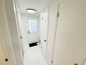 Hall with light tile patterned floors