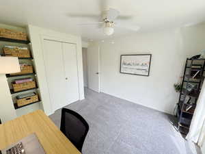Office space featuring baseboards, a ceiling fan, and carpet floors