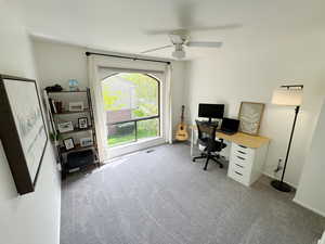 Home office featuring baseboards, ceiling fan, carpet flooring, and visible vents