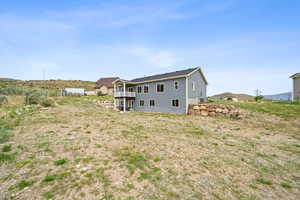 Back of house featuring a balcony