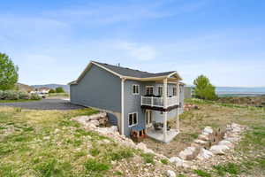 View of property exterior featuring a patio area and a deck
