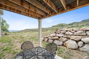 View of yard featuring outdoor dining space and a mountain view