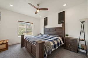 Carpeted bedroom with baseboards, a ceiling fan, and recessed lighting