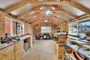 Interior space with vaulted ceiling and a workshop area