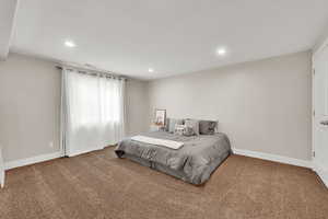 Bedroom featuring carpet, visible vents, baseboards, and recessed lighting