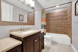 Bathroom featuring toilet, vanity, visible vents, tile patterned floors, and shower / bathtub combination with curtain