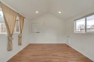 Empty room featuring light wood-style floors, a healthy amount of sunlight, and recessed lighting