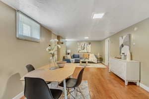 Dining room featuring light wood finished floors and baseboards