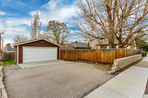 Detached garage featuring fence