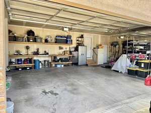 Garage featuring freestanding refrigerator