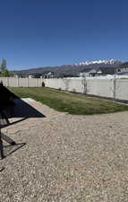 View of yard featuring fence and a mountain view