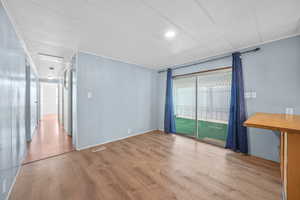 Empty room with visible vents and wood finished floors