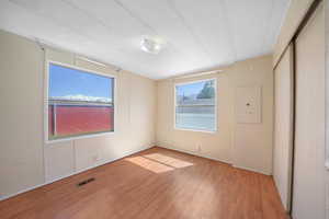 Unfurnished bedroom featuring visible vents and light wood-style flooring