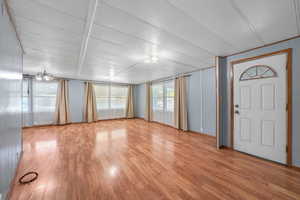Interior space featuring light wood-style floors and a textured ceiling