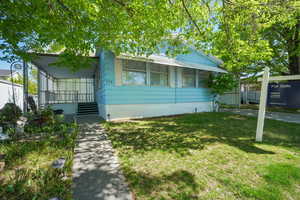 View of front of house with crawl space and a front yard