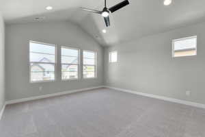 Spare room with ceiling fan, lofted ceiling, baseboards, light carpet, and recessed lighting