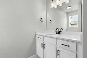 Bathroom featuring vanity and baseboards