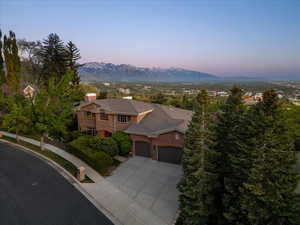 View of front of home , a mountain view, and brick siding