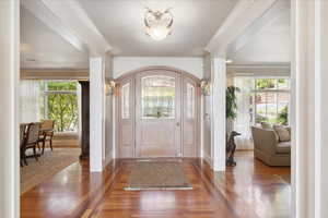 Entrance foyer featuring baseboards and hardwood floors