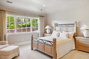 Bedroom with baseboards, recessed lighting, visible vents, and light colored carpet