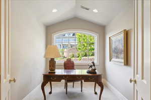 Studio/office space featuring vaulted ceiling