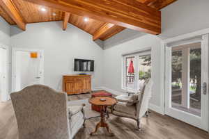Living room featuring beam ceiling, high vaulted ceiling, recessed lighting, wood ceiling, and light wood-style floors