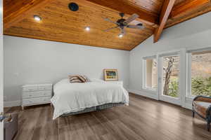 Bedroom with wood ceiling, baseboards, access to exterior, and vaulted ceiling with beams