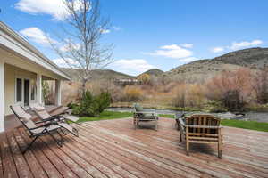 Wooden terrace featuring a mountain view