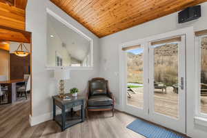 Entryway featuring baseboards, wood ceiling, and wood finished floors