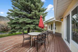 Wooden terrace featuring outdoor dining area