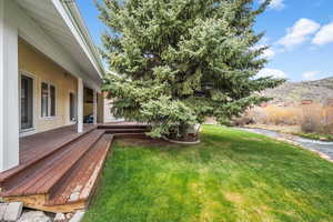 View of yard featuring a deck with mountain view
