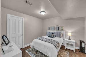 Bedroom with baseboards and visible vents