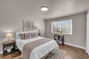 Bedroom featuring baseboards and concrete floors
