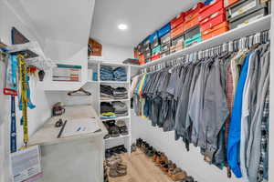 Walk in closet with wood finished floors