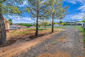 View of road featuring a mountain view and driveway