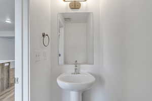 Bathroom featuring a sink and wood finished floors