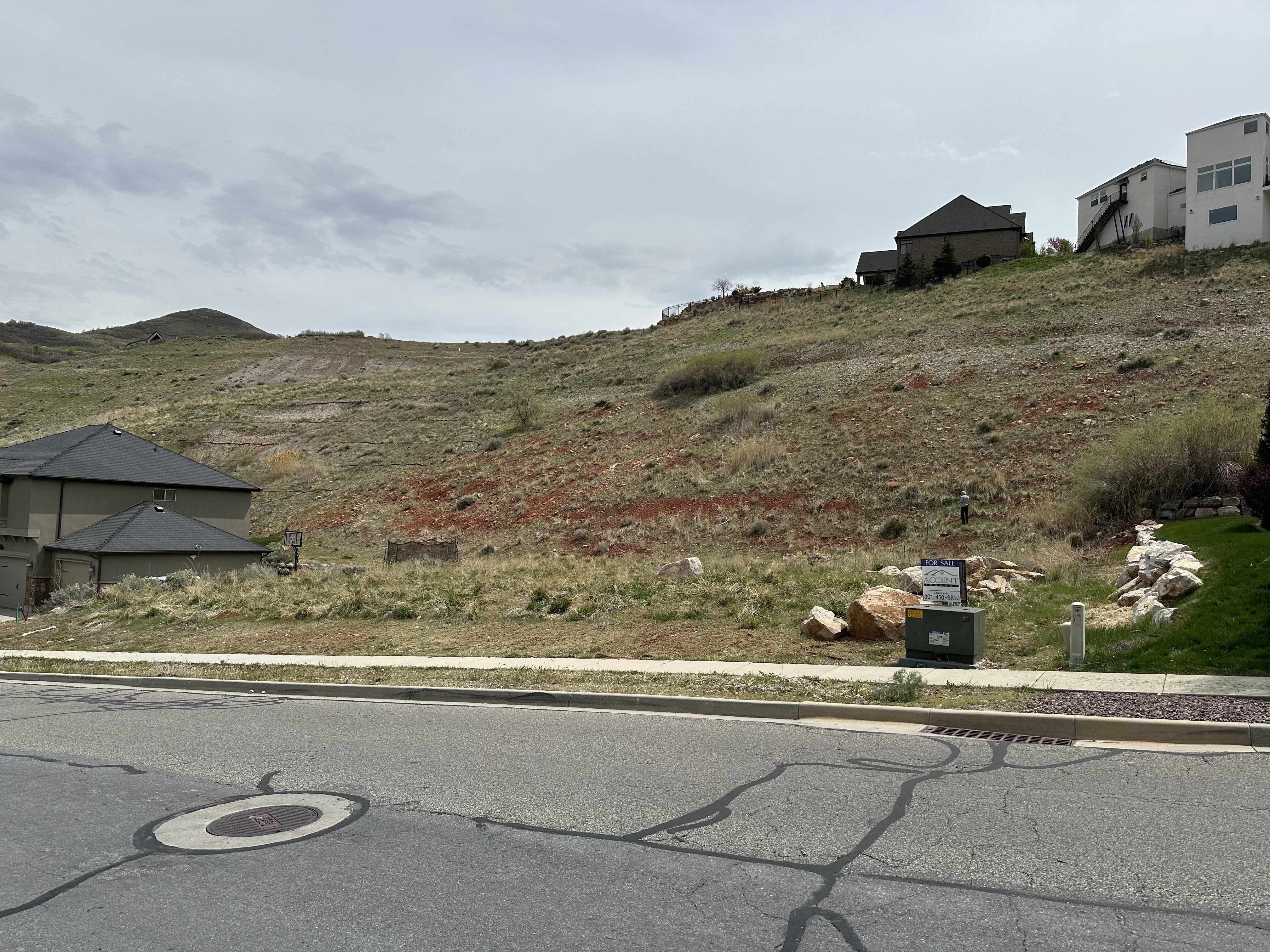 Exterior space featuring a mountain view, curbs, and sidewalks