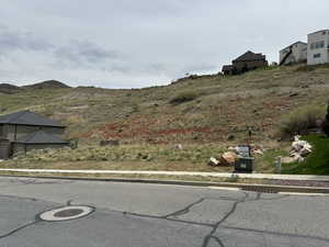 Exterior space featuring a mountain view, curbs, and sidewalks