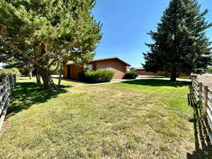 View of yard featuring fence