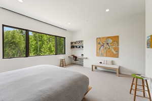 Bedroom with built in study area, recessed lighting, and carpet flooring