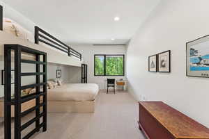Bedroom with light colored carpet and recessed lighting