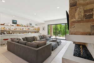 Living room featuring recessed lighting, bar, and light wood-style flooring