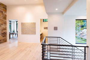 Stairs featuring wood finished floors and recessed lighting