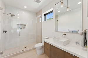 Full bathroom with vanity, a stall shower, recessed lighting, and light tile patterned flooring