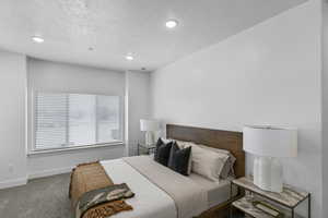 Bedroom featuring carpet flooring, a textured ceiling, baseboards, and recessed lighting