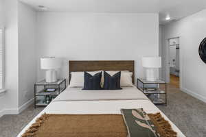 Carpeted bedroom featuring baseboards