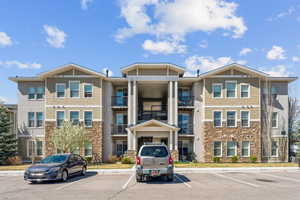 View of building exterior featuring uncovered parking