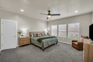 Bedroom featuring baseboards, ceiling fan, visible vents, and carpet floors