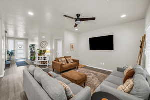 Living area featuring ceiling fan, recessed lighting, baseboards, and wood finished floors