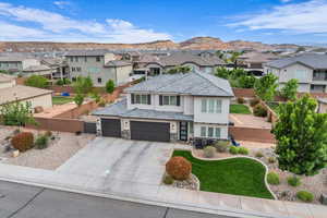 View of front of property with a residential view, a tiled roof, stucco siding, concrete driveway, and fence private yard